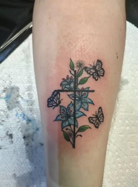 Cross wrapped in blue flowers with butterflies, in color
