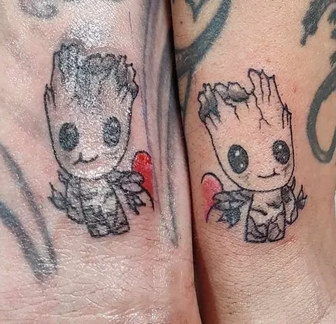 Two matching Baby Groot pieces with red hearts on two arms