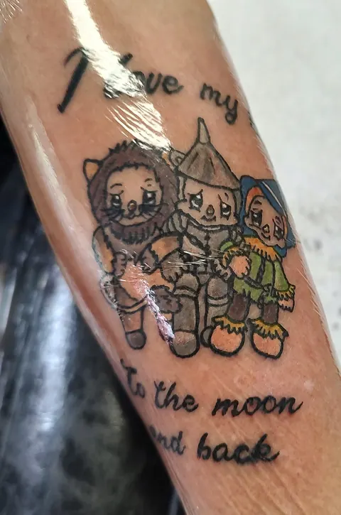 Cartoon characters with the words To the moon and back on the upper arm, in color