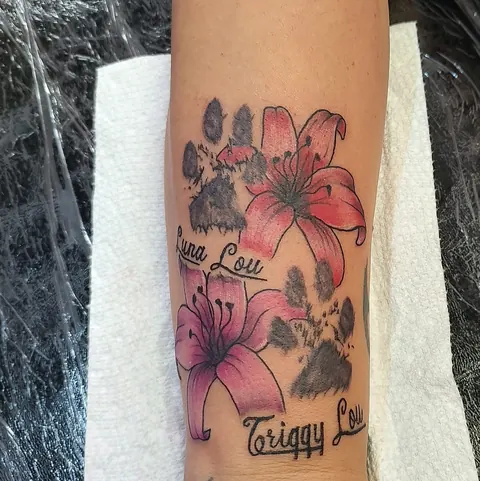 Paw print inside pink lilies with two names in script