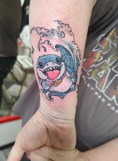 Cartoon shark riding a wave on the wrist, in color