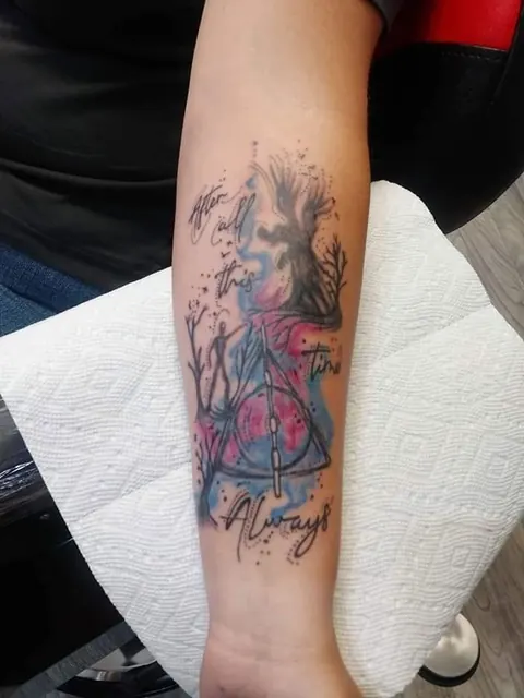 Watercolor style tree with the word Always on the forearm